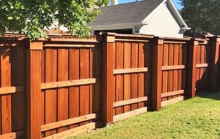 Stain and paint on wood fence